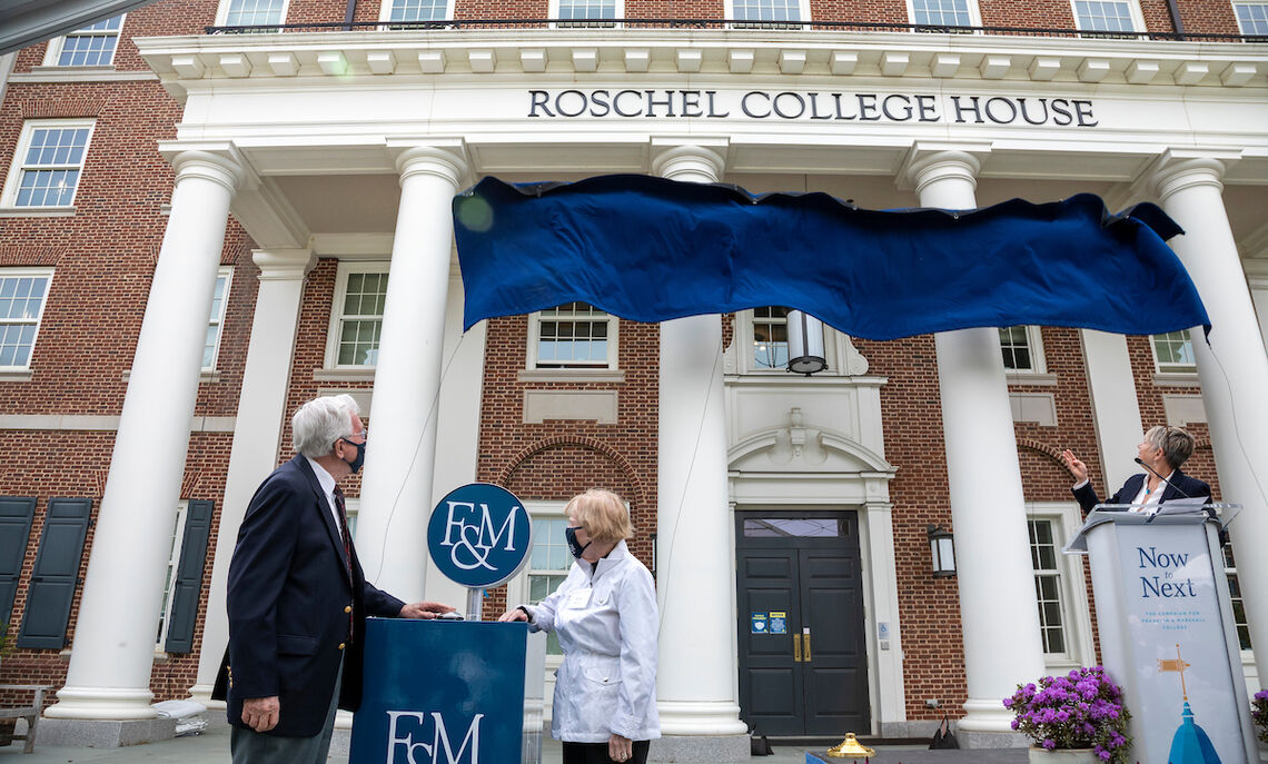 With a light touch, Robert '54 and Anna Roschel unveil the residence's new name.