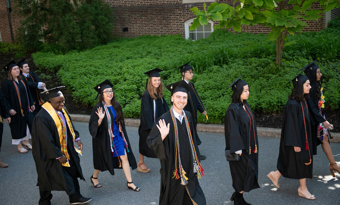 Graduates begin the procession to Commencement ceremonies on Hartman Green.