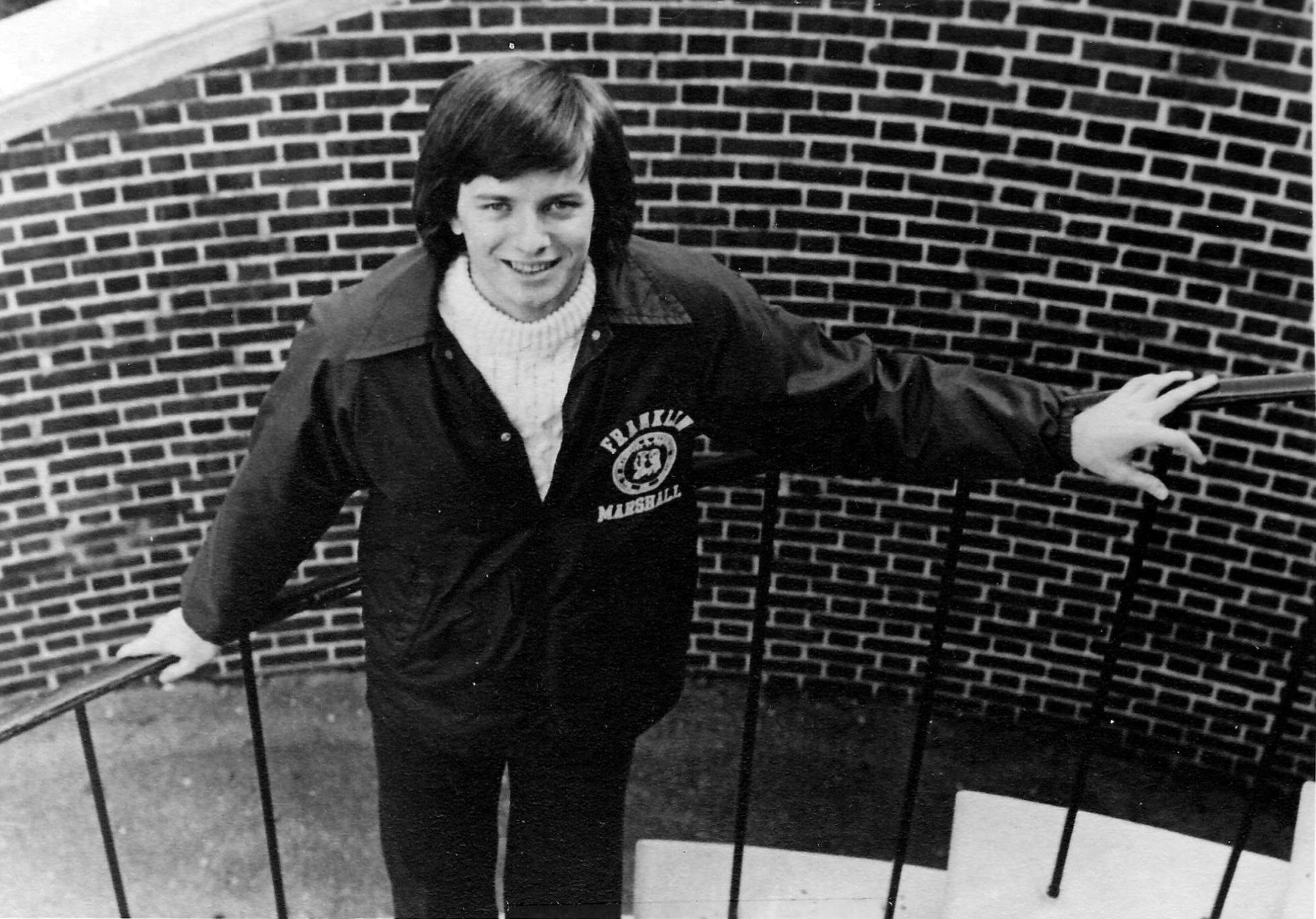 A yearbook photo of Mark Lewis standing in a stairwell.