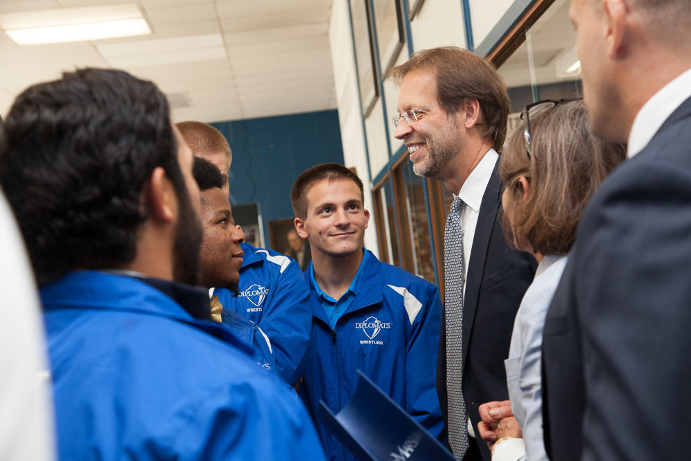 President Daniel R. Porterfield talks with members of the wrestling team following Franklin & Marshall College's announcement Sept. 15 that a $5 million gift from prominent geologist David Lehman, a 1968 alumnus, will endow F&M's NCAA Division I wrestling program for generations of student-athletes to come. (Photo by Melissa Hess)