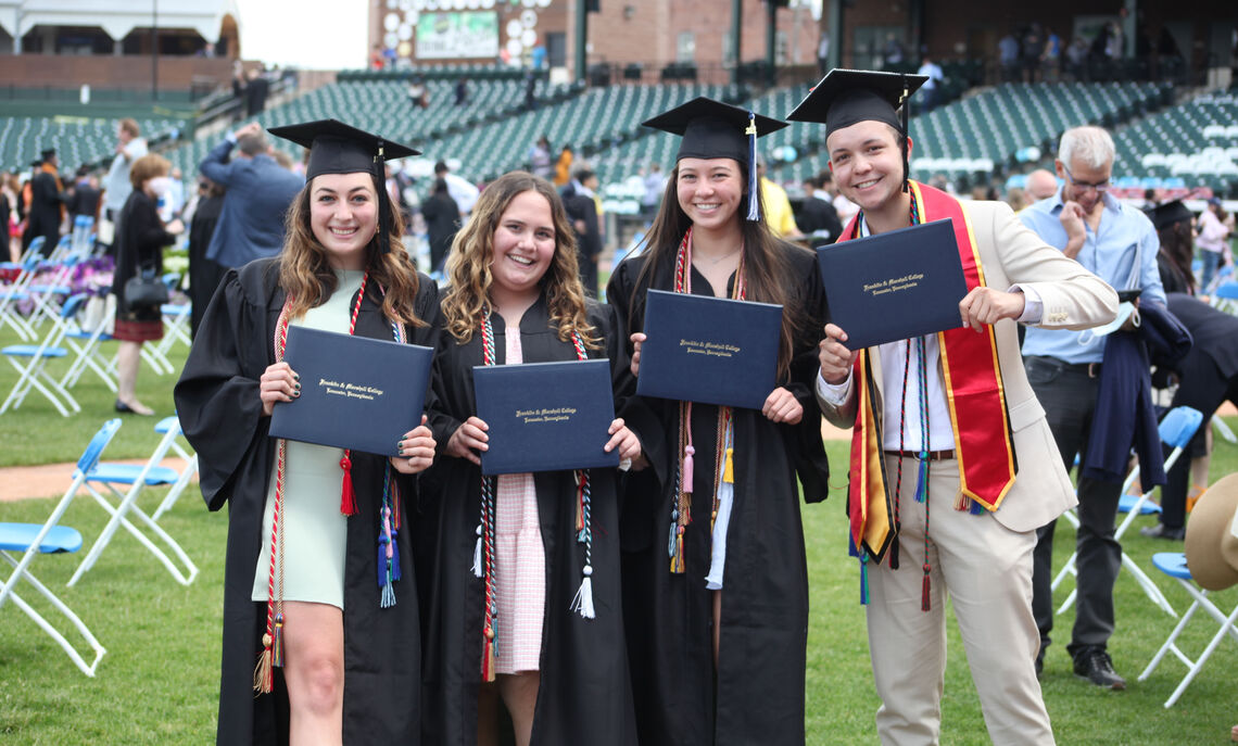 Members of the Class of 2021 display their diplomas during F&M Commencement held May 15 at Lancaster Clipper Stadium.