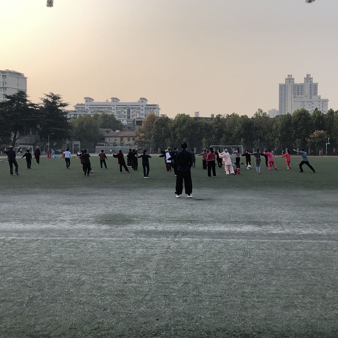 Wuhan residents practicing tai chi as the sun rises.
