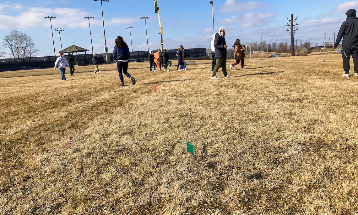 Students search for the wind-blown winged fruit across the field.