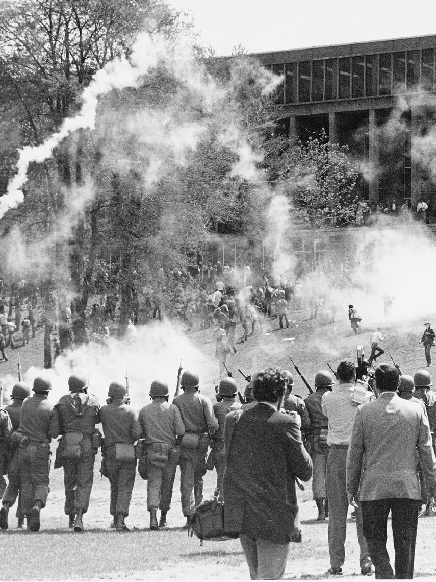 Ohio National Guard soldiers walking toward crowd near Kent State' s Taylor Hall, tear gas has been fired.