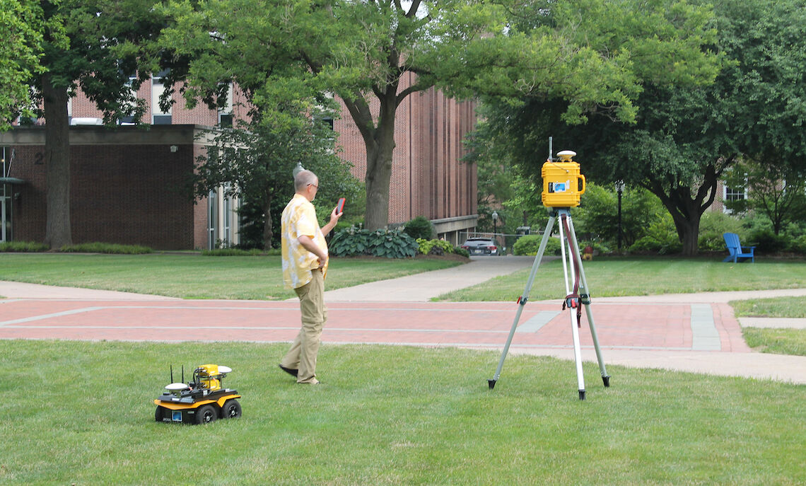 "Jackal" the robot follows Professor Tim Bechtel, director of F&M Science Outreach and senior teaching professor of geosciences, around Hartman Green.