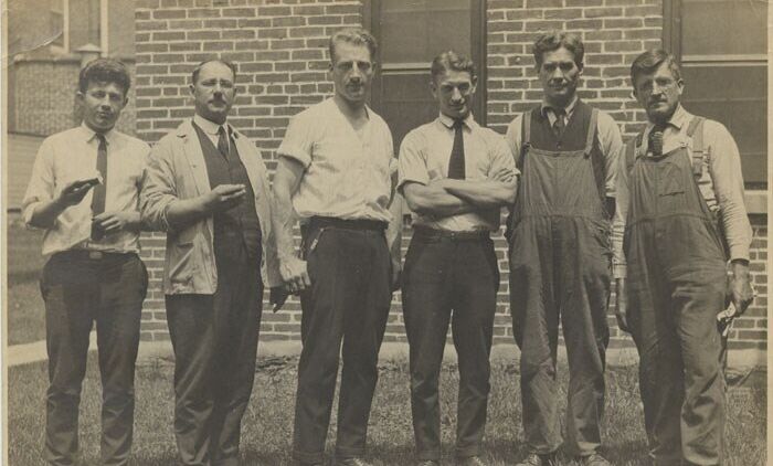 Group of men posed in front of Stehli Silk Mill, 1920