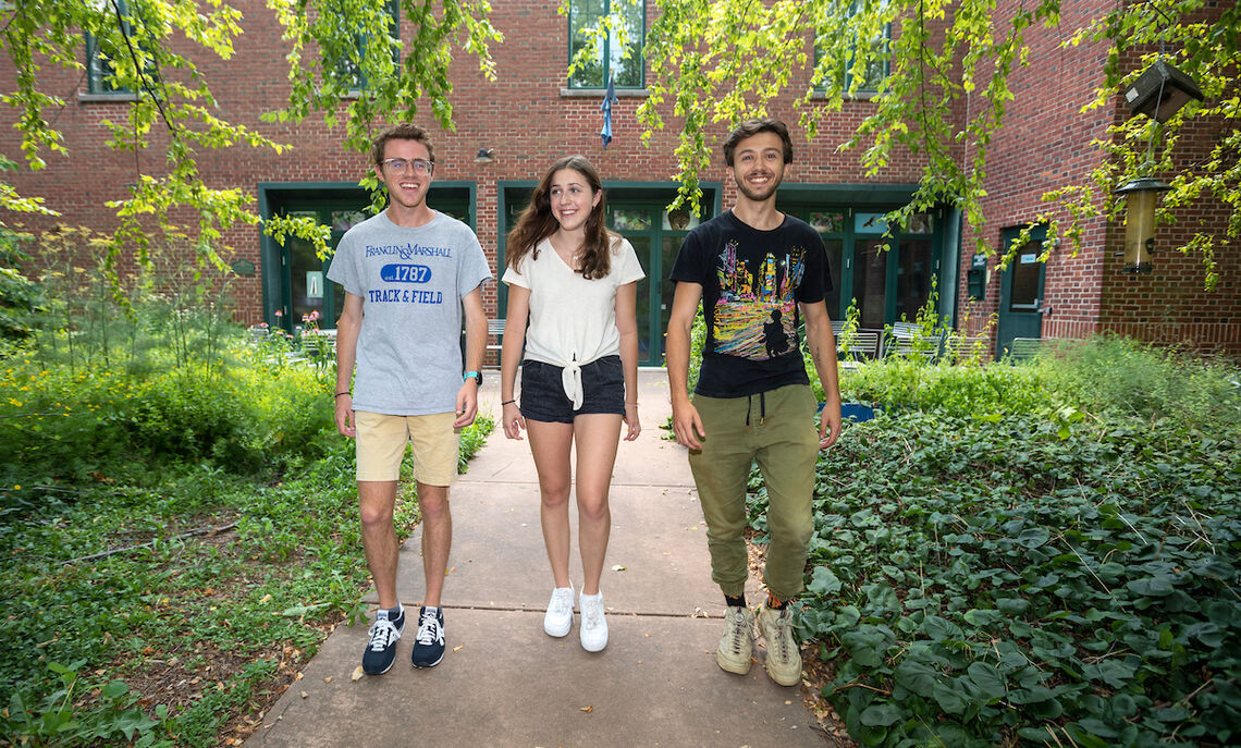 Bennett Wasch '23, Maddie Huelbig '22 and Max Sano '22 gather outside the Center for the Sustainable Environment
