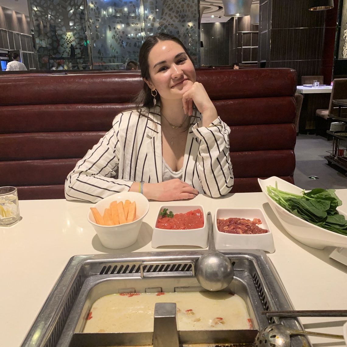 Chappell enjoys a hot pot meal in Wuhan. The traditional Chinese dish consists of sliced meats and vegetables simmered in broth.