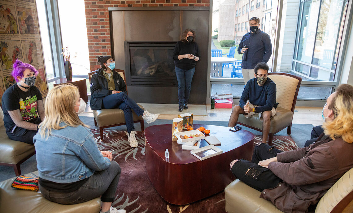 Students enjoy a fireside chat at Brooks College House.