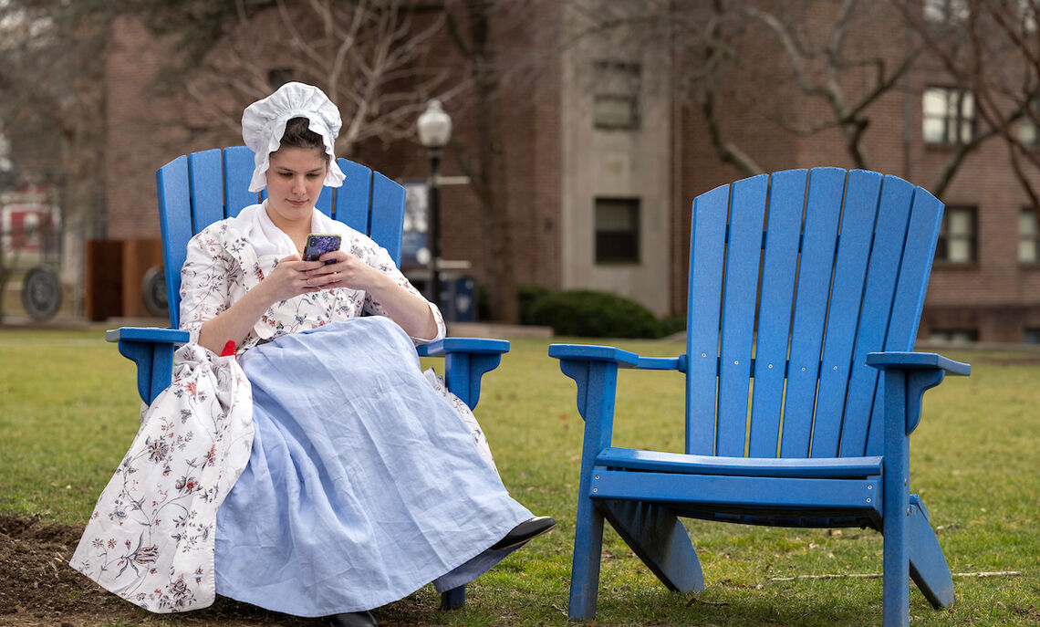 Colonial girl in a modern world: Historic clothing designer Rachel Sheffield '20 takes a break on campus.