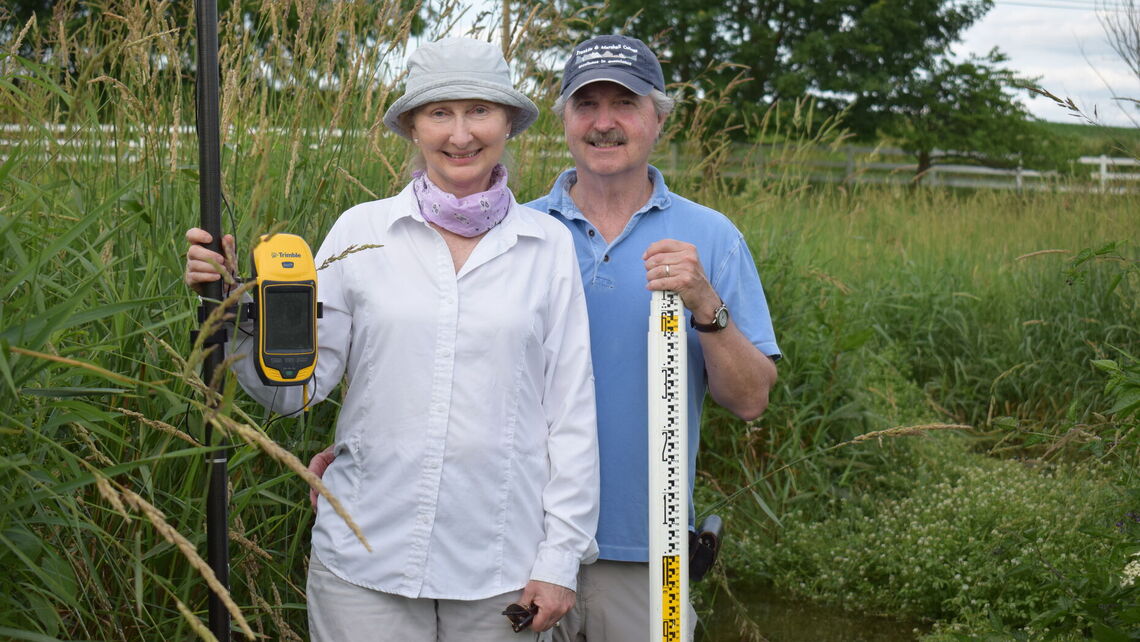 Merritts and Walter in the field doing water and land restoration work.