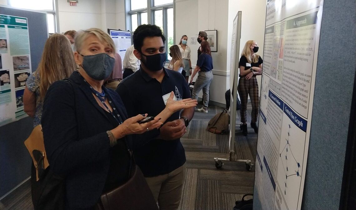 F&M President Barbara Altmann comments on Saad Mahboobs research poster, which was part of the 2021 Summer Experience Fair in October.