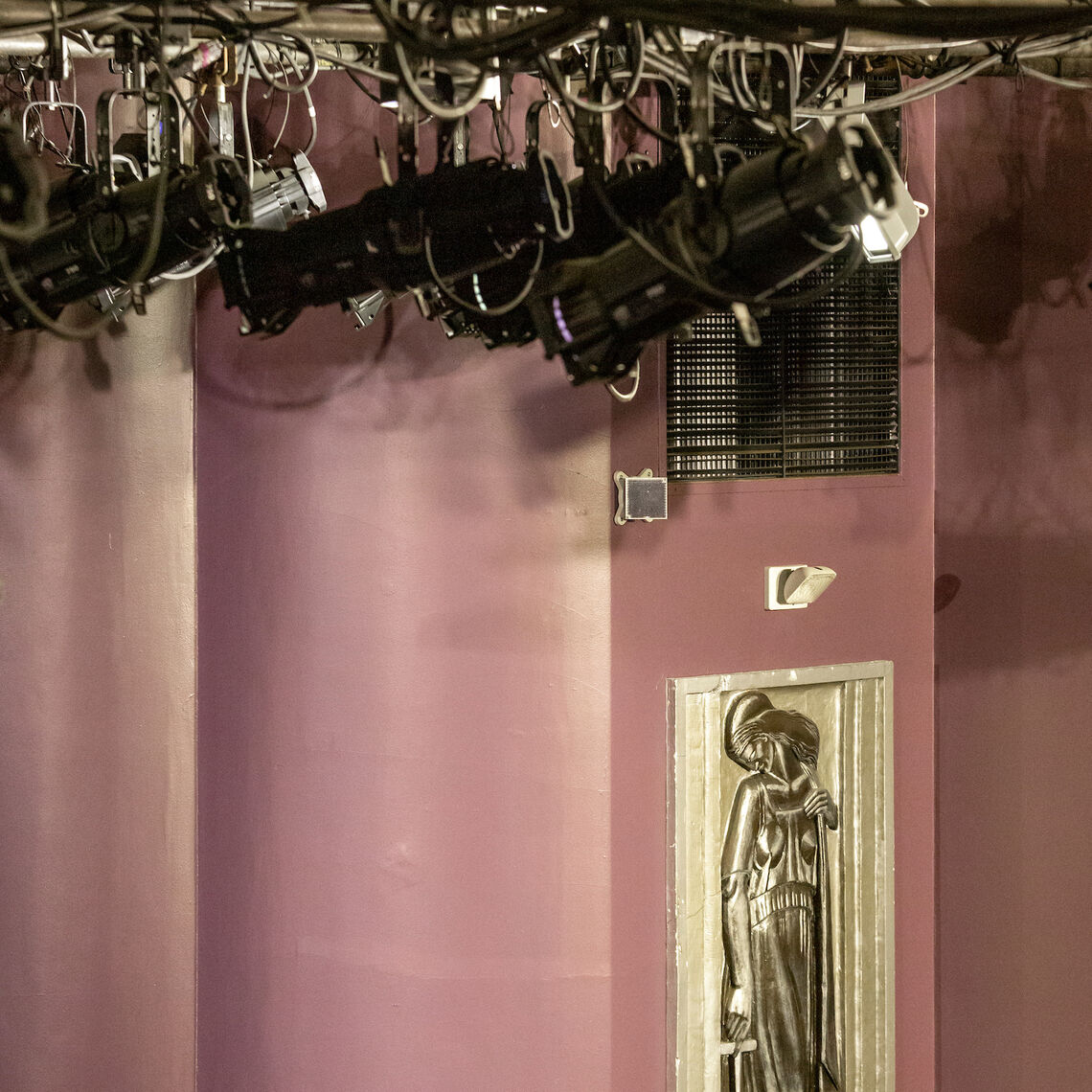 Stage lights hang high above the Art Deco interior of the theatre.