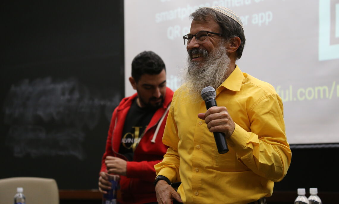 Activist Shadi Abu Awwad, left, and rabbi Hanan Schlesinger discuss their work with Roots.