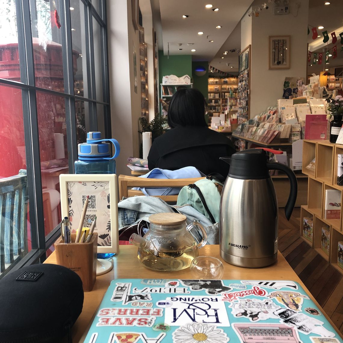 A window seat at  Momi CafÃ© in Wuhan, China. Can you spot the F&M sticker?