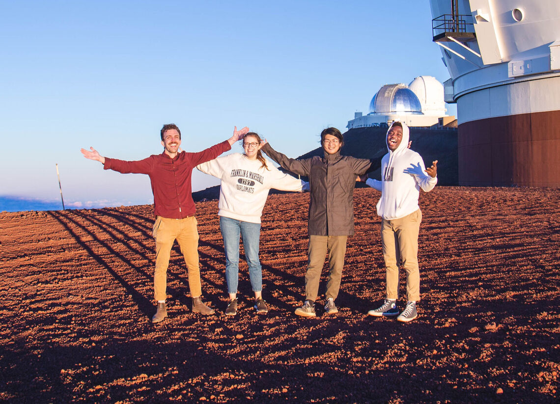 Professor Trainor with seniors Becca McClain and Issac Lin and junior Ojima Abraham atop Hawaiis Mauna Kea to look at the galaxies.